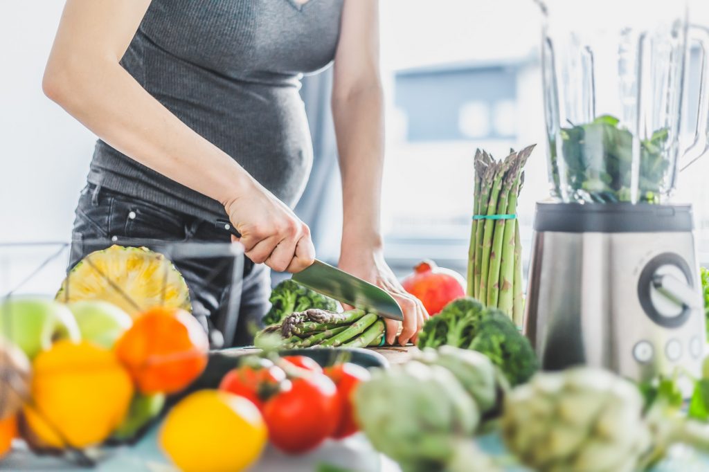 Pregnant woman cooking healthy food